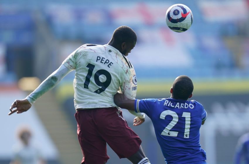 Arsenal's French-born Ivorian midfielder Nicolas Pepe (L) vies with Leicester City's Portuguese defender Ricardo Pereira (R) during the English Premier League football match between Leicester City and Arsenal at King Power Stadium in Leicester, central England on February 28, 2021. (Photo by Tim Keeton / POOL / AFP) / RESTRICTED TO EDITORIAL USE. No use with unauthorized audio, video, data, fixture lists, club/league logos or 'live' services. Online in-match use limited to 120 images. An additional 40 images may be used in extra time. No video emulation. Social media in-match use limited to 120 images. An additional 40 images may be used in extra time. No use in betting publications, games or single club/league/player publications. / (Photo by TIM KEETON/POOL/AFP via Getty Images)