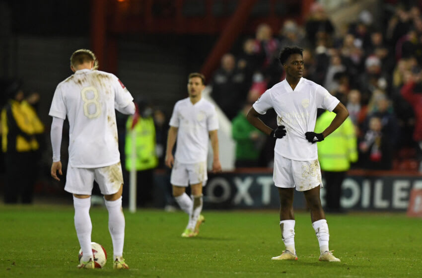 Arsenal's Norwegian midfielder Martin Odegaard (L), Arsenal's German-born Portuguese defender Cedric Soares (C) and Arsenal's Belgian midfielder Albert Sambi Lokonga (R) react to conceding the first goal during the English FA Cup third round football match between Nottingham Forest and Arsenal at The City Ground in Nottingham, central England, on January 9, 2022. - - RESTRICTED TO EDITORIAL USE. No use with unauthorized audio, video, data, fixture lists, club/league logos or 'live' services. Online in-match use limited to 120 images. An additional 40 images may be used in extra time. No video emulation. Social media in-match use limited to 120 images. An additional 40 images may be used in extra time. No use in betting publications, games or single club/league/player publications. (Photo by Daniel LEAL / AFP) / RESTRICTED TO EDITORIAL USE. No use with unauthorized audio, video, data, fixture lists, club/league logos or 'live' services. Online in-match use limited to 120 images. An additional 40 images may be used in extra time. No video emulation. Social media in-match use limited to 120 images. An additional 40 images may be used in extra time. No use in betting publications, games or single club/league/player publications. / RESTRICTED TO EDITORIAL USE. No use with unauthorized audio, video, data, fixture lists, club/league logos or 'live' services. Online in-match use limited to 120 images. An additional 40 images may be used in extra time. No video emulation. Social media in-match use limited to 120 images. An additional 40 images may be used in extra time. No use in betting publications, games or single club/league/player publications. (Photo by DANIEL LEAL/AFP via Getty Images)