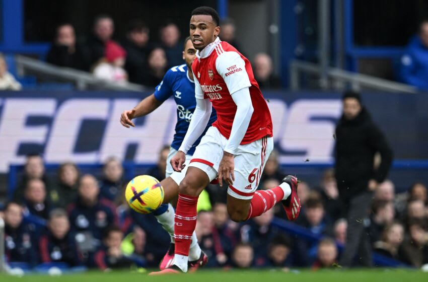 Arsenal's Brazilian defender Gabriel Magalhaes runs with the ball past Everton's English striker Dominic Calvert-Lewin (back) during the English Premier League football match between Everton and Arsenal at Goodison Park in Liverpool, north-west England, on February 4, 2023. - RESTRICTED TO EDITORIAL USE. No use with unauthorized audio, video, data, fixture lists, club/league logos or 'live' services. Online in-match use limited to 120 images. An additional 40 images may be used in extra time. No video emulation. Social media in-match use limited to 120 images. An additional 40 images may be used in extra time. No use in betting publications, games or single club/league/player publications. (Photo by Paul ELLIS / AFP) / RESTRICTED TO EDITORIAL USE. No use with unauthorized audio, video, data, fixture lists, club/league logos or 'live' services. Online in-match use limited to 120 images. An additional 40 images may be used in extra time. No video emulation. Social media in-match use limited to 120 images. An additional 40 images may be used in extra time. No use in betting publications, games or single club/league/player publications. / RESTRICTED TO EDITORIAL USE. No use with unauthorized audio, video, data, fixture lists, club/league logos or 'live' services. Online in-match use limited to 120 images. An additional 40 images may be used in extra time. No video emulation. Social media in-match use limited to 120 images. An additional 40 images may be used in extra time. No use in betting publications, games or single club/league/player publications. (Photo by PAUL ELLIS/AFP via Getty Images)