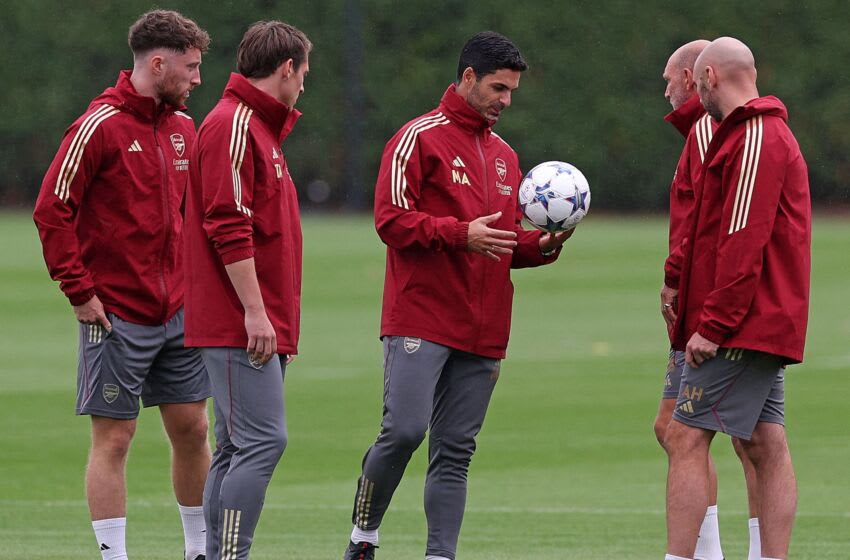 Arsenal's Spanish manager Mikel Arteta (C) looks at a Champions League ball during a team training session at Arsenal's training ground in north London on September 19, 2023, ahead of their UEFA Champions League Group B football match against PSV Eindhoven. (Photo by Adrian DENNIS / AFP) (Photo by ADRIAN DENNIS/AFP via Getty Images)