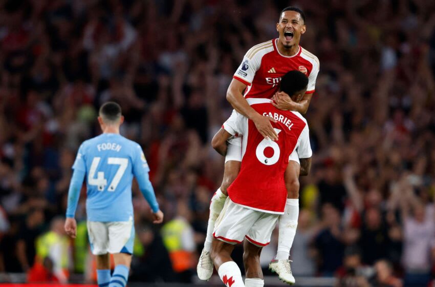 Arsenal's French defender #02 William Saliba and Arsenal's Brazilian defender #06 Gabriel Magalhaes celebrate on the pitch after the English Premier League football match between Arsenal and Manchester City at The Emirates stadium in London on October 8, 2023. Arsenal won the game 1-0. (Photo by Ian Kington / IKIMAGES / AFP) / RESTRICTED TO EDITORIAL USE. No use with unauthorized audio, video, data, fixture lists, club/league logos or 'live' services. Online in-match use limited to 45 images, no video emulation. No use in betting, games or single club/league/player publications. (Photo by IAN KINGTON/IKIMAGES/AFP via Getty Images)